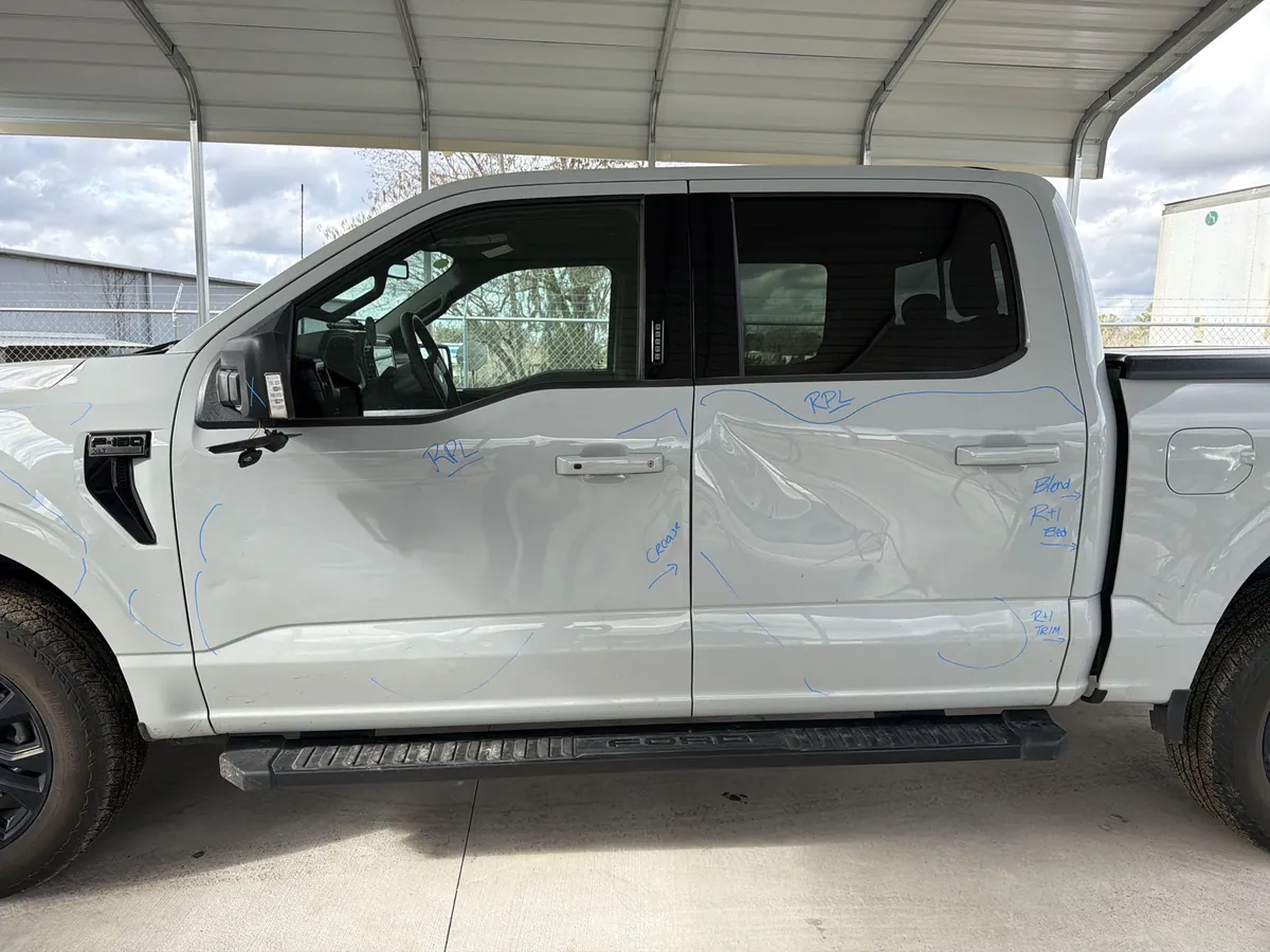 Side impact and panel damage on a 2024 Ford F-150 before repair