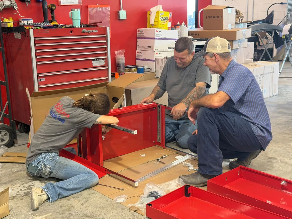 Layla assembling tools for the I-CAR Registered Apprenticeship Program with Eddie Williams and Robert Womble at Williams Paint & Body Shop in Marianna, Florida.